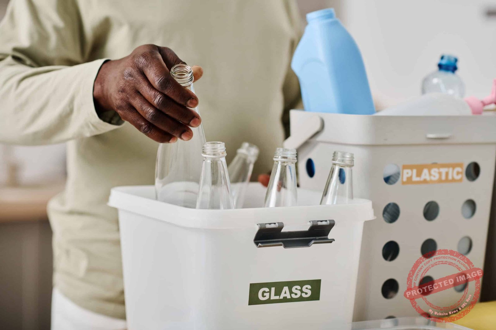 Man separating glass in container for recycling