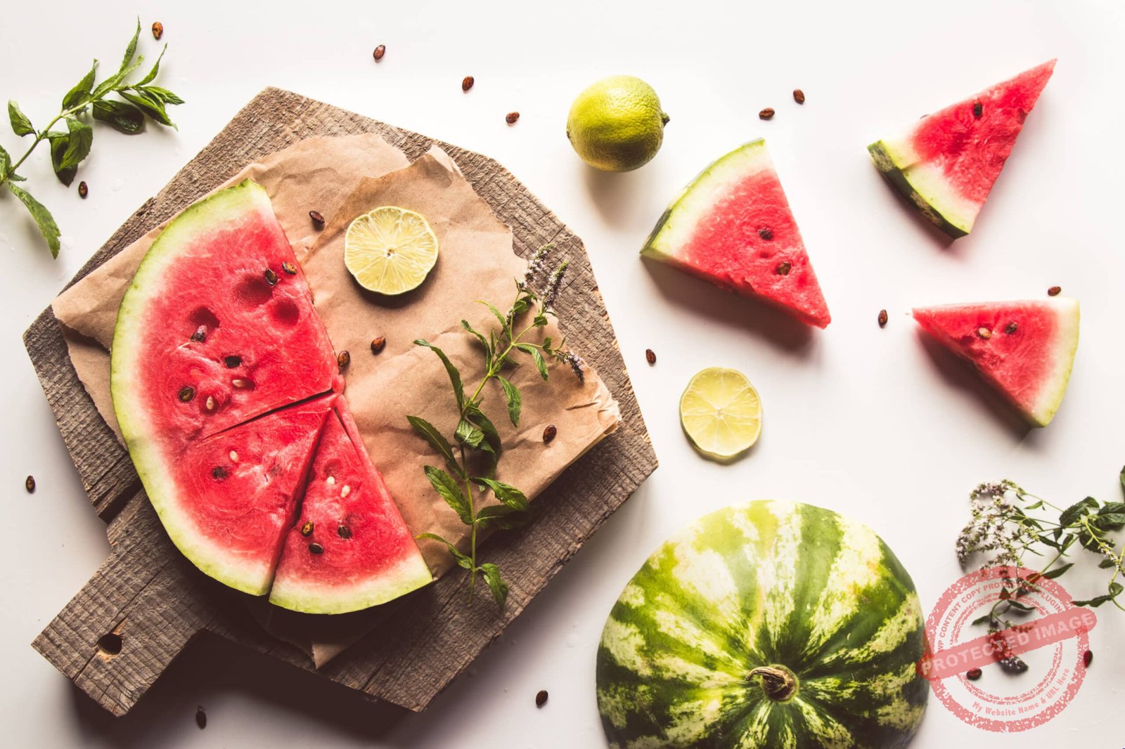 watermelon on a sliced board with mint and slices of lime