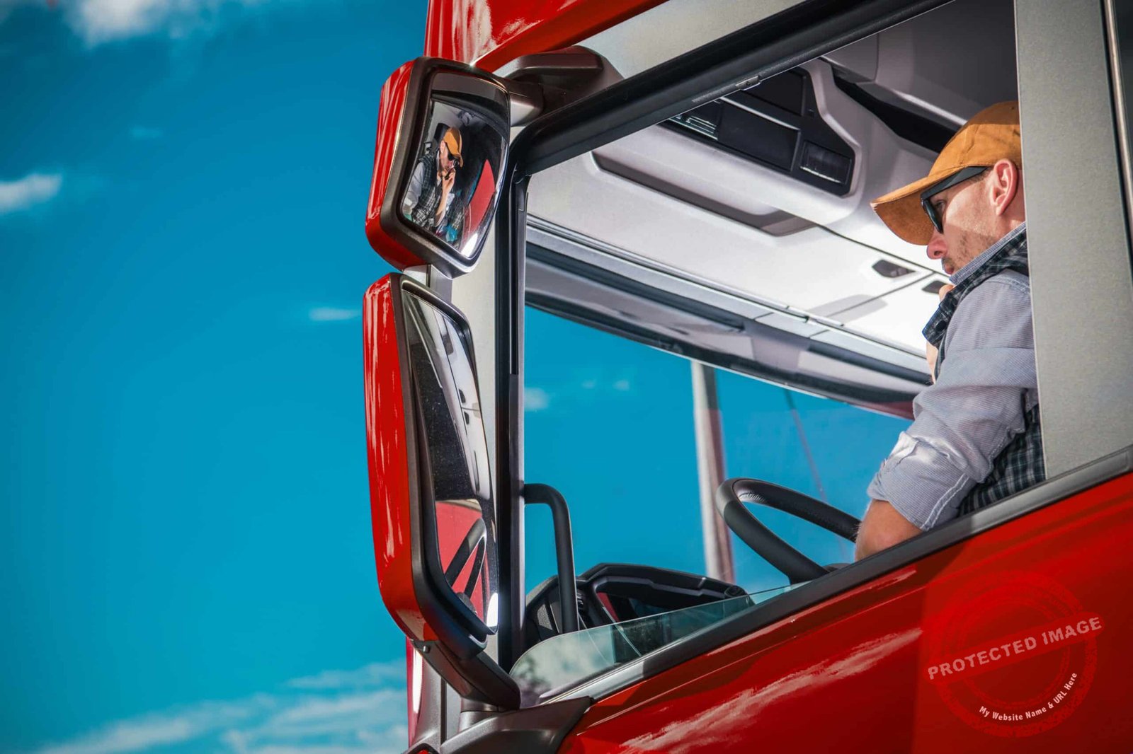 Transportation Industry Theme. Caucasian Truck Driver in His 30s Inside the Red Semi Cabin.