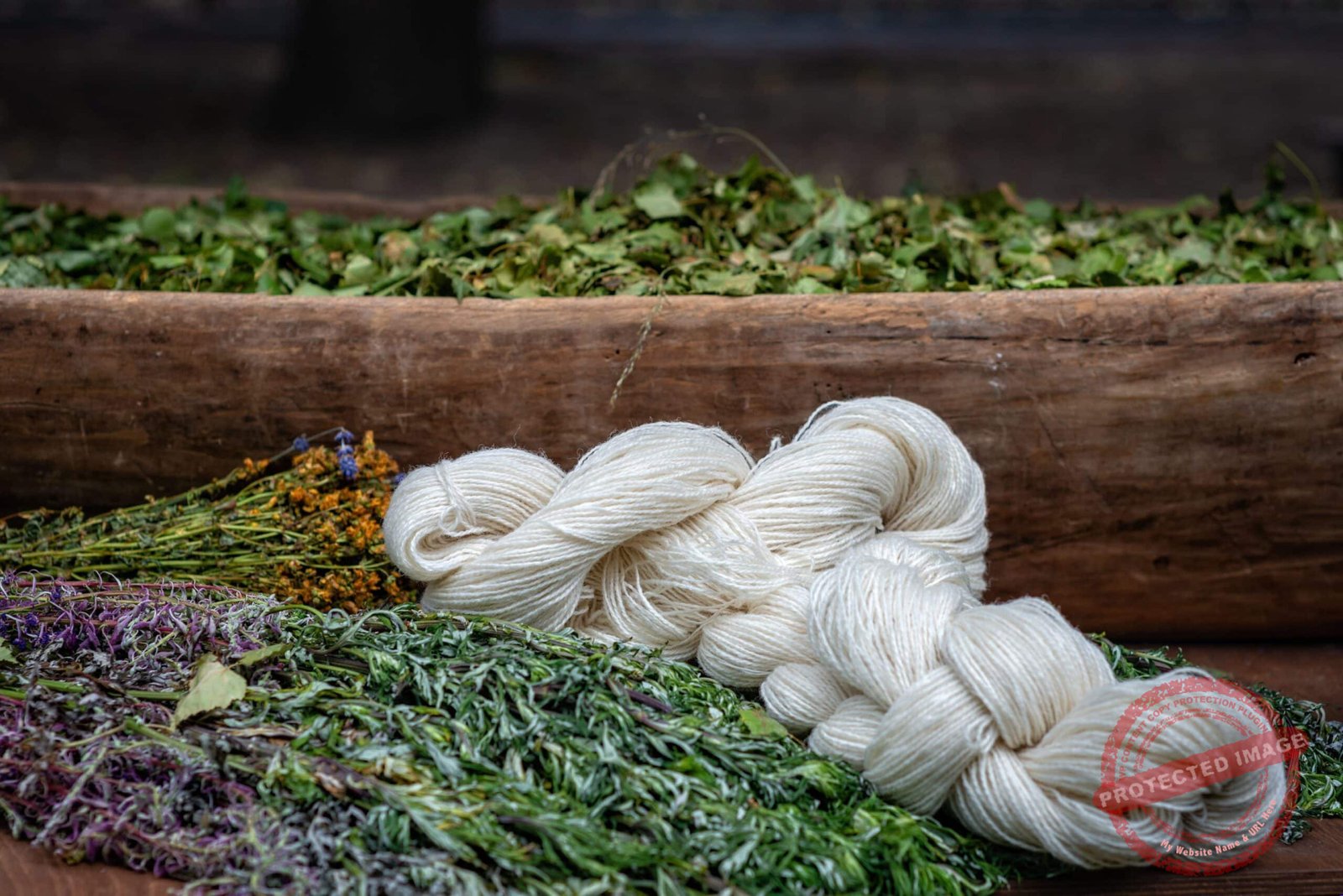 white yarn, dry flowers and grass  in the background at the coun